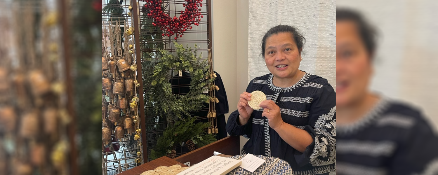 A woman holding up a circular object